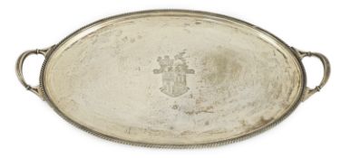A George V silver oval two handled tea tray, by James Dixon & Sons, with engraved crest and