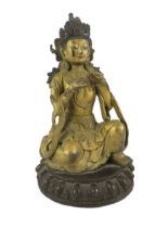 A Chinese gilt bronze figure of a kneeling Bodhisattva, with remnants of polychrome decoration, on a