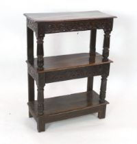 An early 17th century oak three tier buffet with mid tier drawer, turned column supports and stile