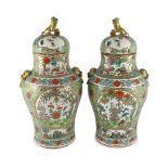 A pair of Chinese enamelled porcelain vases and covers, early 20th century, each painted with
