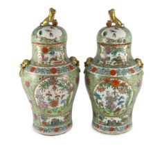 A pair of Chinese enamelled porcelain vases and covers, early 20th century, each painted with