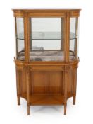 An Edwardian inlaid satinwood display cabinet of D shaped form with central glazed door over an