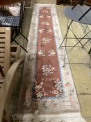Two Chinese fawn ground floral runners, both 360cm x 70cm.***CONDITION REPORT***PLEASE NOTE:-
