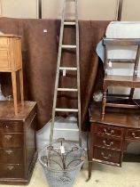 A vintage wooden window cleaner's ladder, height 250cm, two wirework garden baskets and a wrought