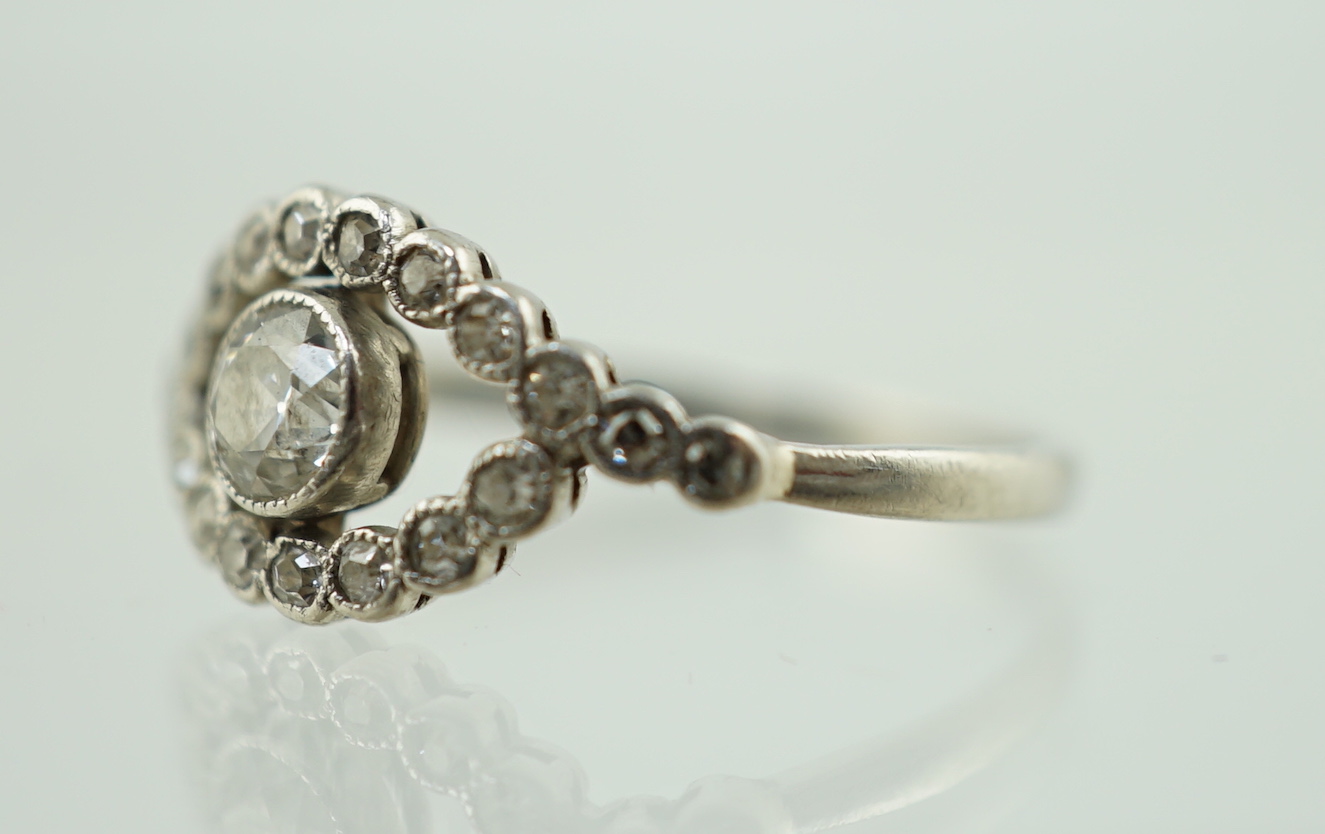 A white metal and single stone elliptical shaped ring, with diamond set border and shoulders, size - Image 2 of 5