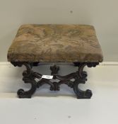 A Victorian carved and upholstered rectangular 'X' framed oak dressing stool, width 56cm, depth