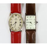 A 14k white metal Jules Jurgensen oval manual wind dress wrist watch, on an associated red leather