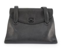 A black Chanel CC shoulder bag features a leather body, flat leather straps, a flap with a twist