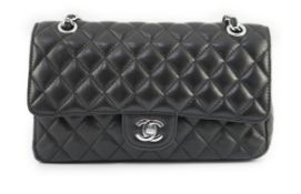 A Chanel classic black quilted leather shoulder bag with sliding chain strap, brand hardware at