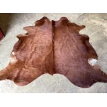 A cow skin rug, approx. 180 x 160cm***CONDITION REPORT***PLEASE NOTE:- Prospective buyers are