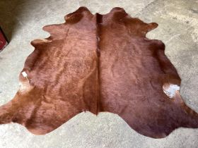 A cow skin rug, approx. 180 x 160cm***CONDITION REPORT***PLEASE NOTE:- Prospective buyers are