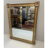 An early 19th century style giltwood rectangular overmantel, with cream and gilt foliate inset