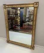 An early 19th century style giltwood rectangular overmantel, with cream and gilt foliate inset