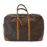 A Louis Vuitton Keepall leather travel bag with luggage tag in brown monogram canvas and natural