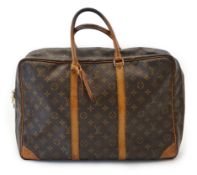 A Louis Vuitton Keepall leather travel bag with luggage tag in brown monogram canvas and natural