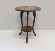 An early 20th century Liberty style carved two tier occasional table, diameter 44cm, height 61cm***