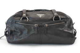 A Prada Cargo black leather handbag, triangle black and silver metal logo, dust bag, width 38cm,