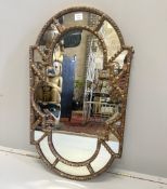 A Victorian carved giltwood and gesso shaped oval mirror, with marginal plates, width 57cm, height