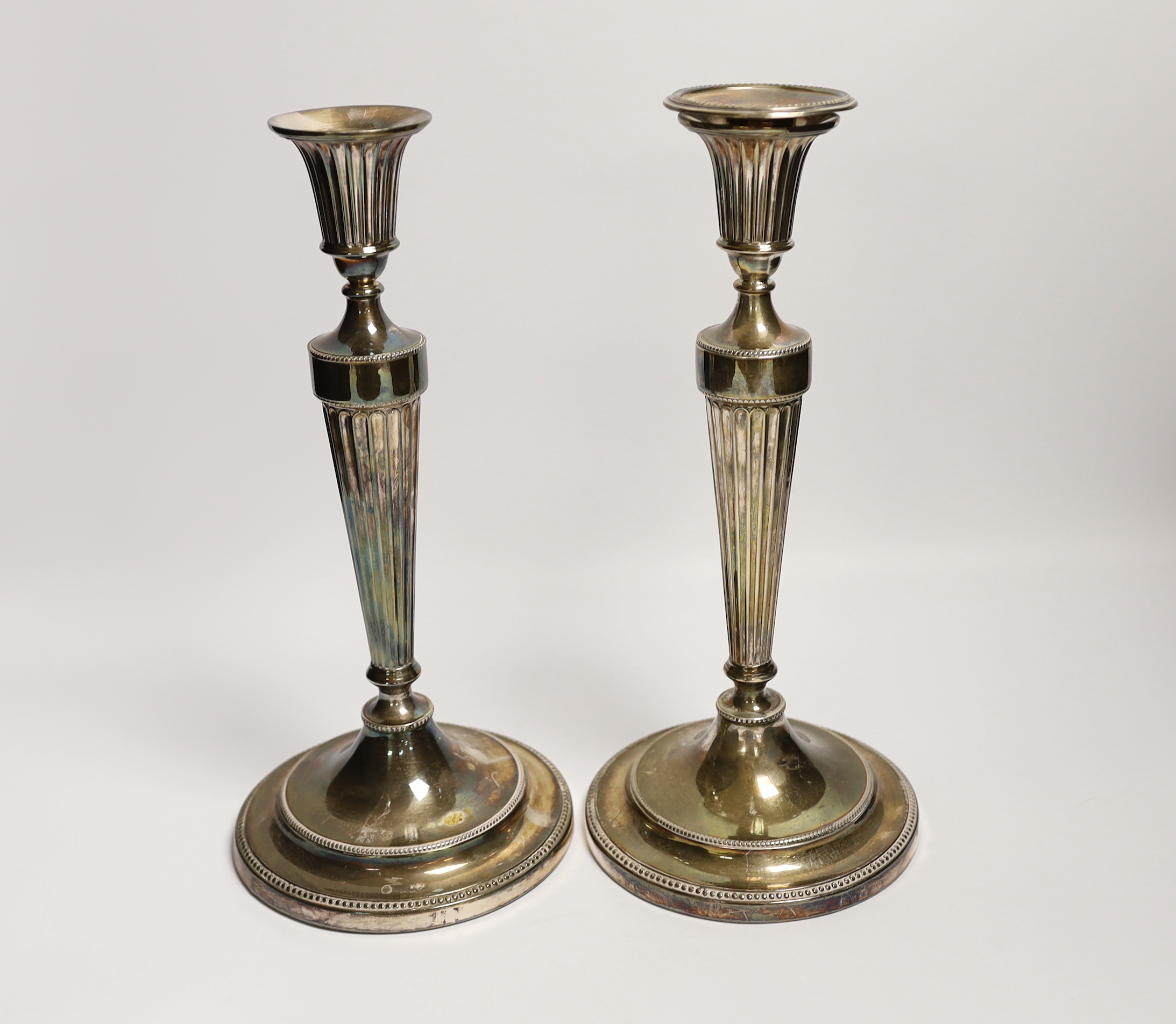 A pair of George III silver candlesticks, with waisted fluted stems, John Winter & Co, Sheffield,