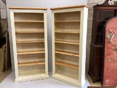 A pair of modern cream painted tall pine open bookcases with adjustable shelves, width 96cm, depth