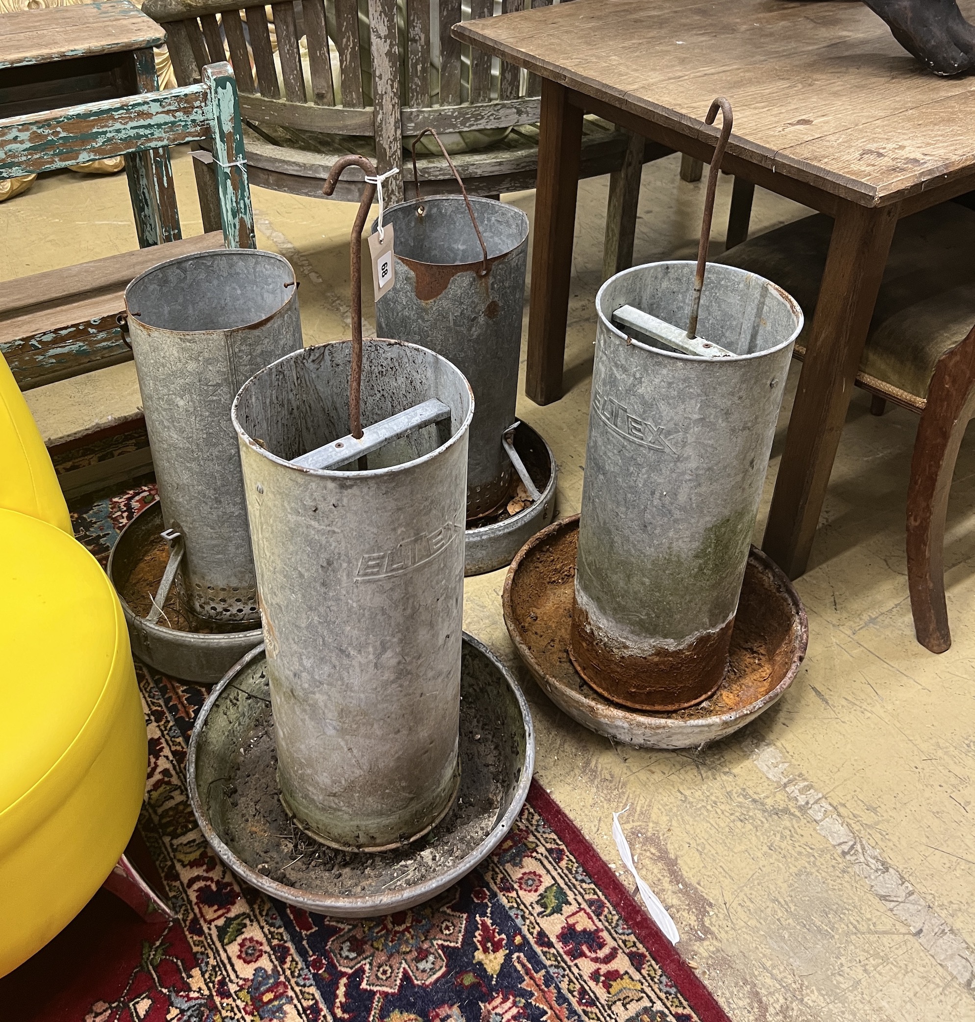Four vintage galvanised poultry feeders, largest height 62cm***CONDITION REPORT***PLEASE NOTE:-