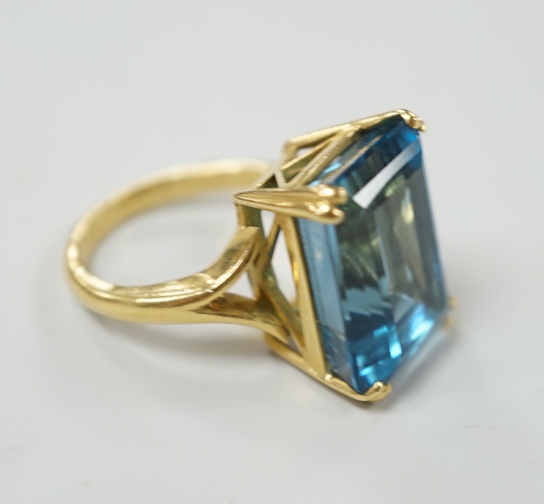 An 18ct and emerald cut blue topaz set dress ring, size K, gross weight 11 grams.***CONDITION - Image 2 of 3