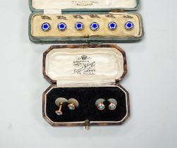 A cased set of six white metal and enamel dress studs and four other dress studs.***CONDITION