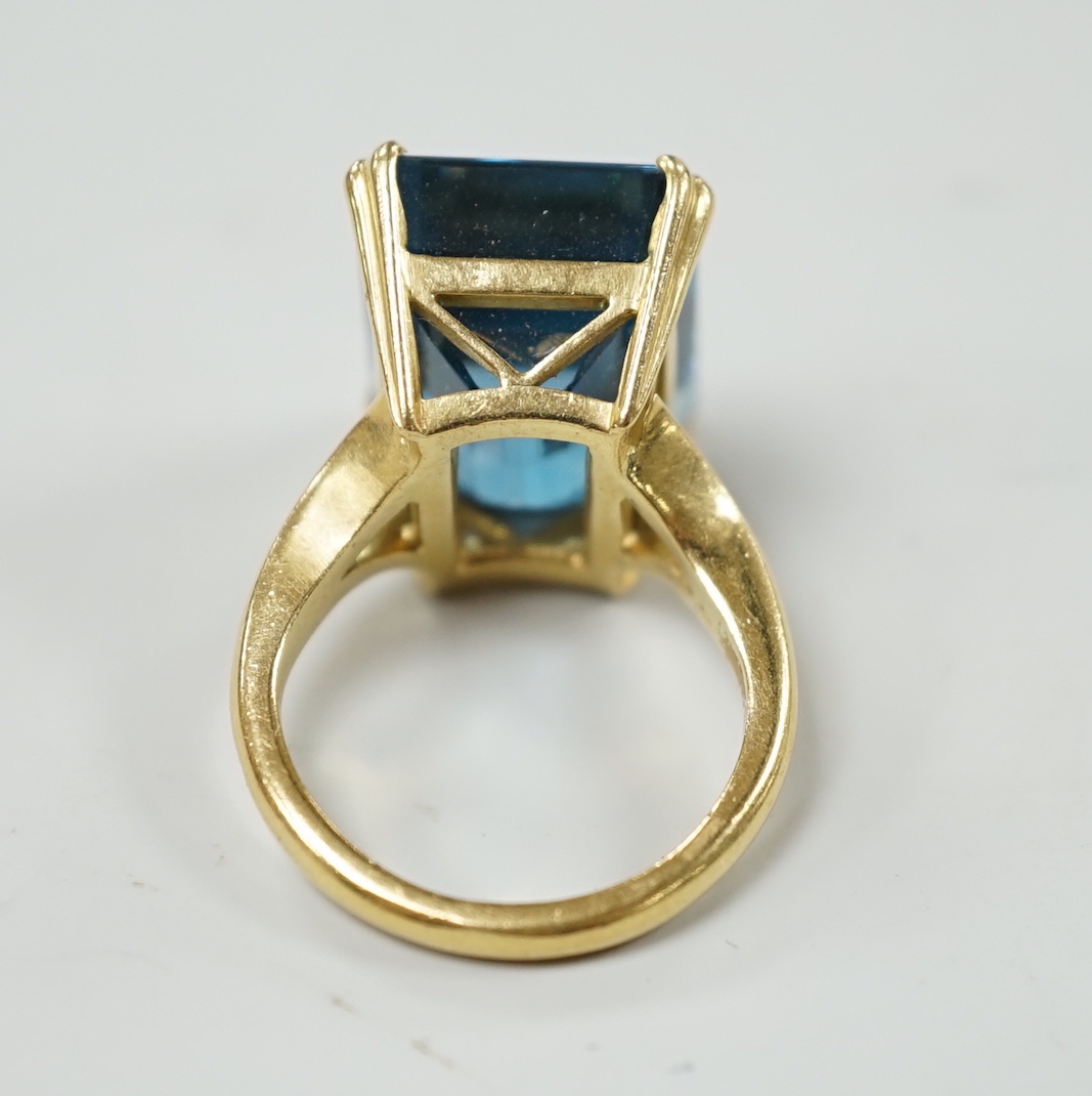 An 18ct and emerald cut blue topaz set dress ring, size K, gross weight 11 grams.***CONDITION - Image 3 of 3