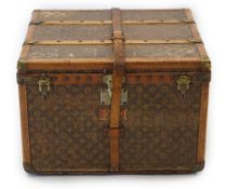 A vintage Louis Vuitton trunk in monogram canvas with brass mounted wooden protection slats and