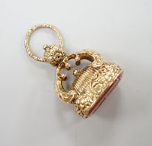 A 19th century yellow metal overlaid and carnelian set fob seal, the matrix carved with crest and
