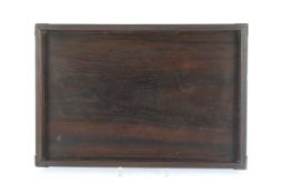 A Chinese hardwood rectangular tray, Qing dynasty, possibly Zitan, with brass mounted corners and