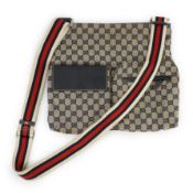 A Gucci GG monogram navy double pocket messenger bag, with cream, navy and red web shoulder strap,