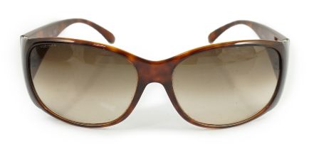 A pair of Prada tortoiseshell sunglasses with hard case***CONDITION REPORT***A little dirty but