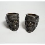 A pair of late 19th century skull shaped pewter match holders, 5cm tall***CONDITION REPORT***
