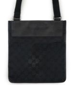 A Gucci black GG canvas crossbody bag features a canvas body with leather trim, flat strap, open