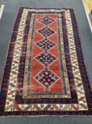 An antique Anatolian brick red ground rug, 244 x 140cm***CONDITION REPORT***PLEASE NOTE:-