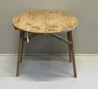 A 19th century French circular pine folding occasional table, diameter 75cm, height 68cm***CONDITION