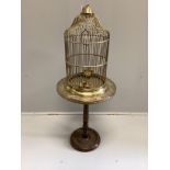 A brass birdcage on circular brass top occasional table, combined height 110cm***CONDITION