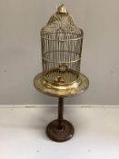 A brass birdcage on circular brass top occasional table, combined height 110cm***CONDITION