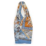 A Hermès silk cravat in ethnographic pattern, Hermes blue and brown tones, length 127cm x 18cm***