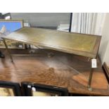 A mid century rectangular brass and mahogany leather topped coffee table with lion paw feet, width