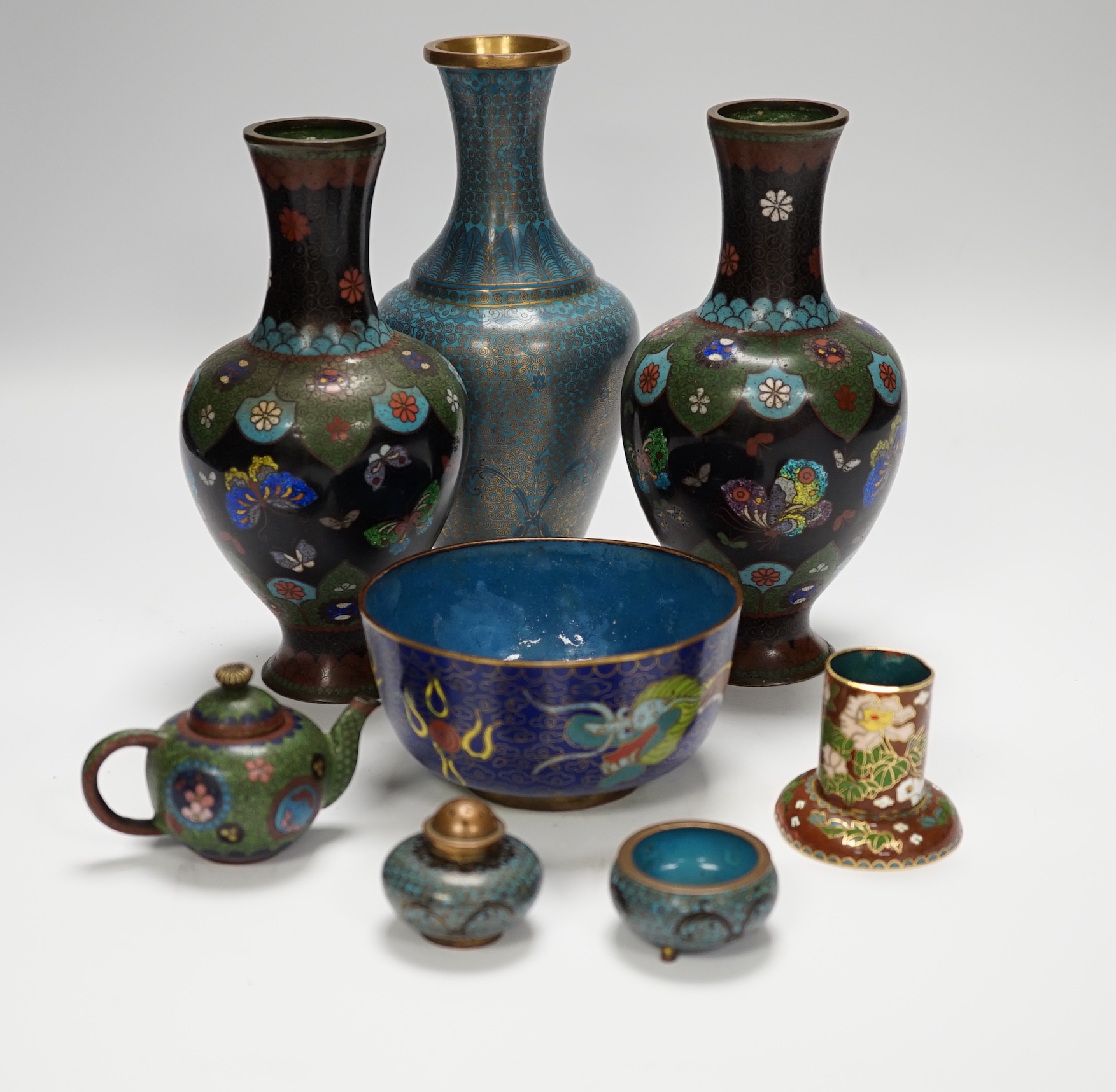 A collection of Chinese and Japanese cloisonné enamel pieces, including five vases, a ginger jar and