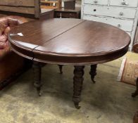 A 19th century and later Continental mahogany circular extending dining table, length approx.