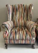 A pair of Edwardian wing armchairs, upholstered in contemporary striped fabric, width 74cm, depth