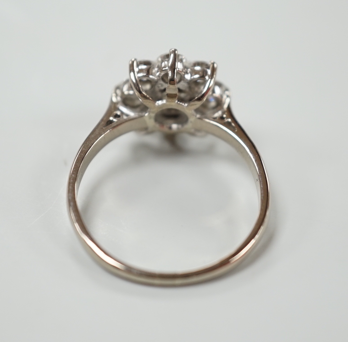 An 18ct, plat. and nine stone diamond set flower head cluster ring, the central stone weighing - Image 4 of 4