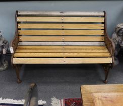 A Victorian Coalbrookdale passion flower pattern cast iron garden bench restored with later ash