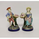 A pair of 19th century Worcester majolica figures holding baskets, largest 17cm high***CONDITION