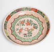 A Chinese famille verte dish, Kangxi period, decorated with flowers bands of brocade patterns,