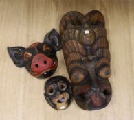 A Ceylonese painted wood mask, an East Java mask and a pig mask, largest 50cm long***CONDITION