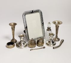 Sundry small silver including a pair of dwarf candlesticks, condiments, napkin ring, spill vases and